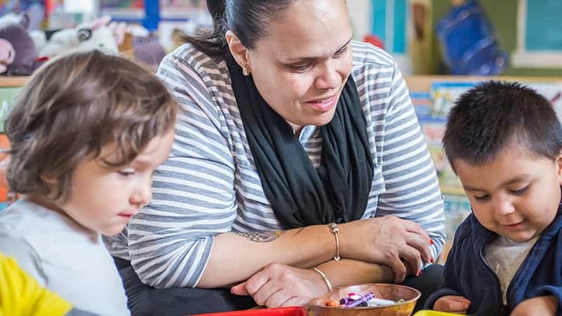 Teacher helping students with activity