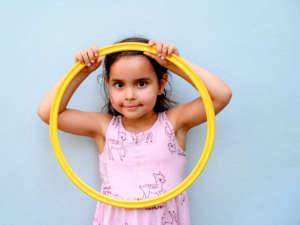 Educare Miami student holding yellow hula hoop