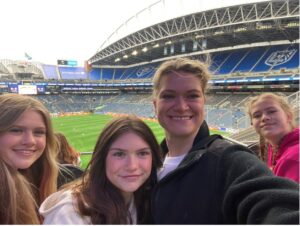 Trish and her three daughters at a ball game